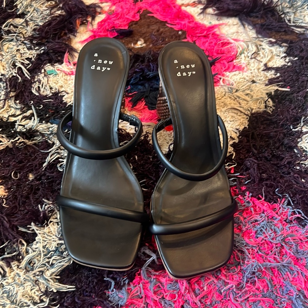 Black sandals with snakeskin heel